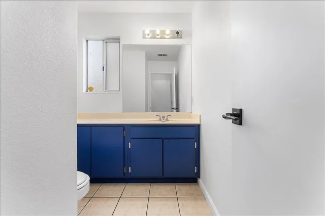 a bathroom with a toilet a sink and mirror