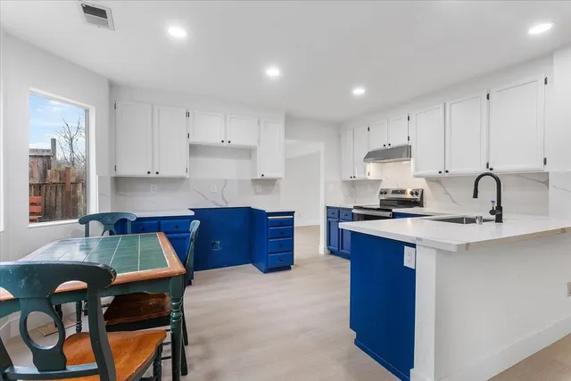 a kitchen with a wooden cabinets and stove