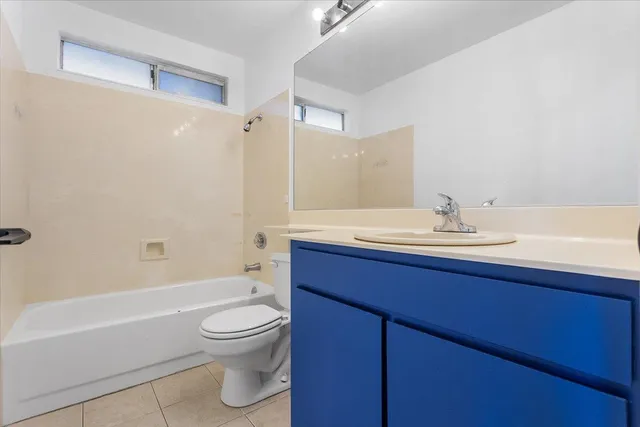 a white toilet sitting next to a bathroom sink