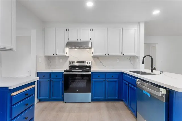 a kitchen with stainless steel appliances granite countertop a sink stove and cabinets