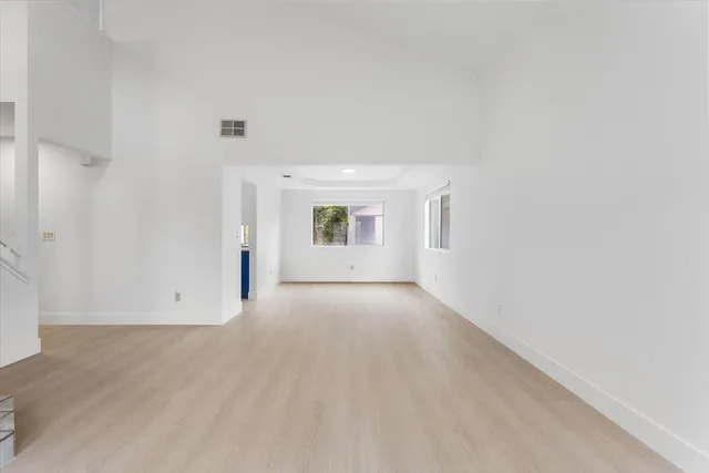 an empty room with a kitchen and a sink