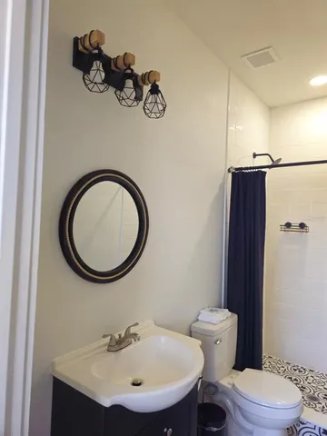 a bathroom with a sink a large mirror and a shower