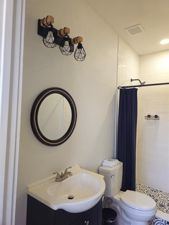 4472 Mariner Road Bonita Springs, FL 34134 - Photo 15 of 36 a bathroom with a sink a mirror a toilet and a mirror