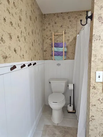 a bedroom with two beds and window