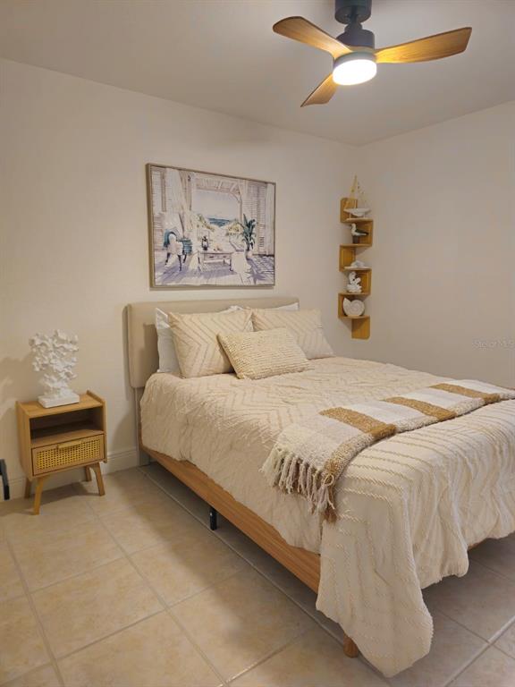 4472 Mariner Road Bonita Springs, FL 34134 - Photo 21 of 36 a bedroom with a bed and a chandelier