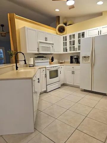 a view of kitchen with stainless steel appliances granite countertop a sink and a refrigerator