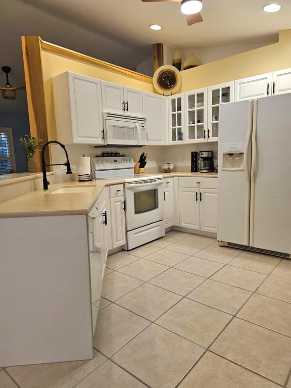 4472 Mariner Road Bonita Springs, FL 34134 - Photo 25 of 36 a kitchen with a sink cabinets and appliances