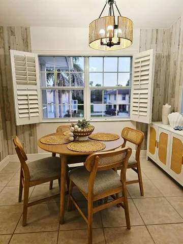 a view of a dining room with furniture wooden floor and a chandelier