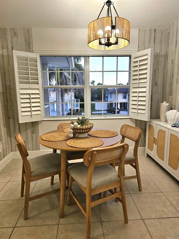 4472 Mariner Road Bonita Springs, FL 34134 - Photo 28 of 36 a view of a dining room with furniture wooden floor and a chandelier