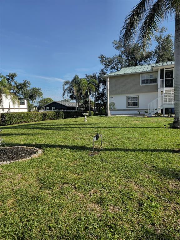 4472 Mariner Road Bonita Springs, FL 34134 - Photo 3 of 36 a front view of a house with a yard