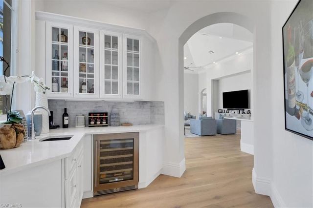 a kitchen with stainless steel appliances a sink stove and cabinets