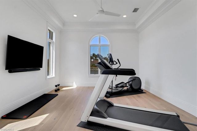 a room with gym equipment and a flat screen tv