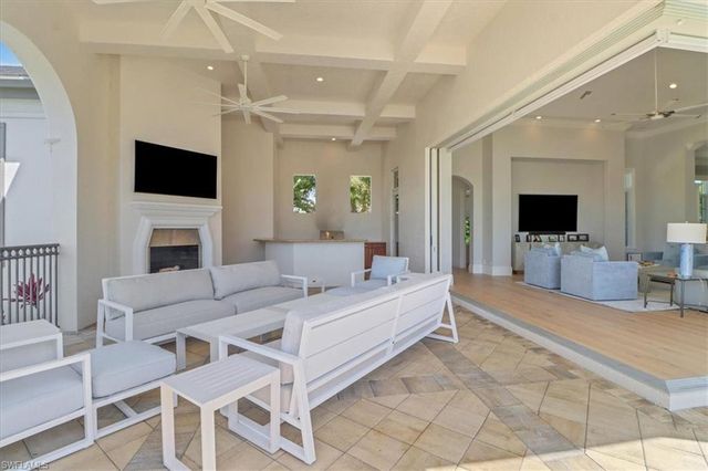a living room with fireplace furniture and a flat screen tv