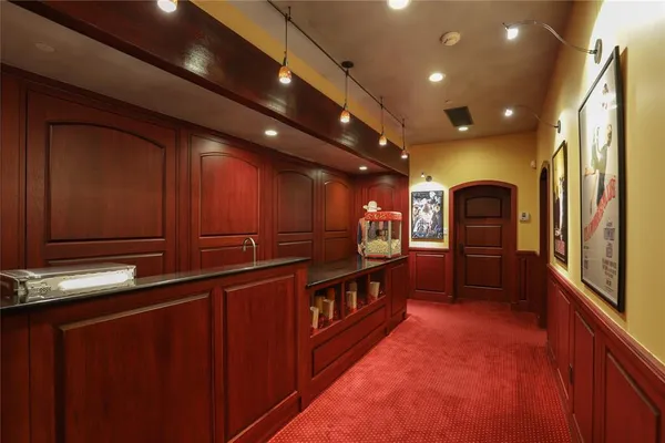 a view of kitchen with refrigerator and sink