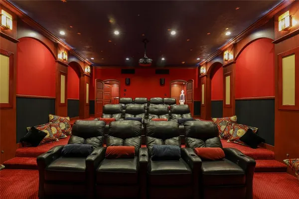 a media room with lots of chairs and a projector screen