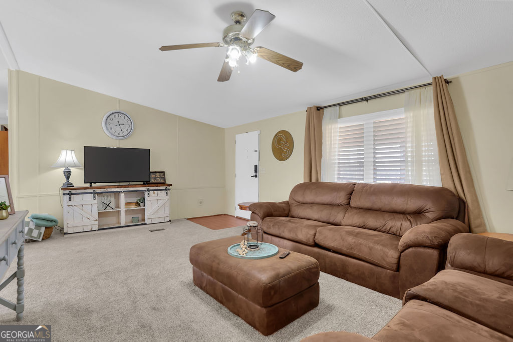 1775 Stoopto Road Sylvania, GA 30467 - Photo 2 of 66 a living room with furniture and a flat screen tv
