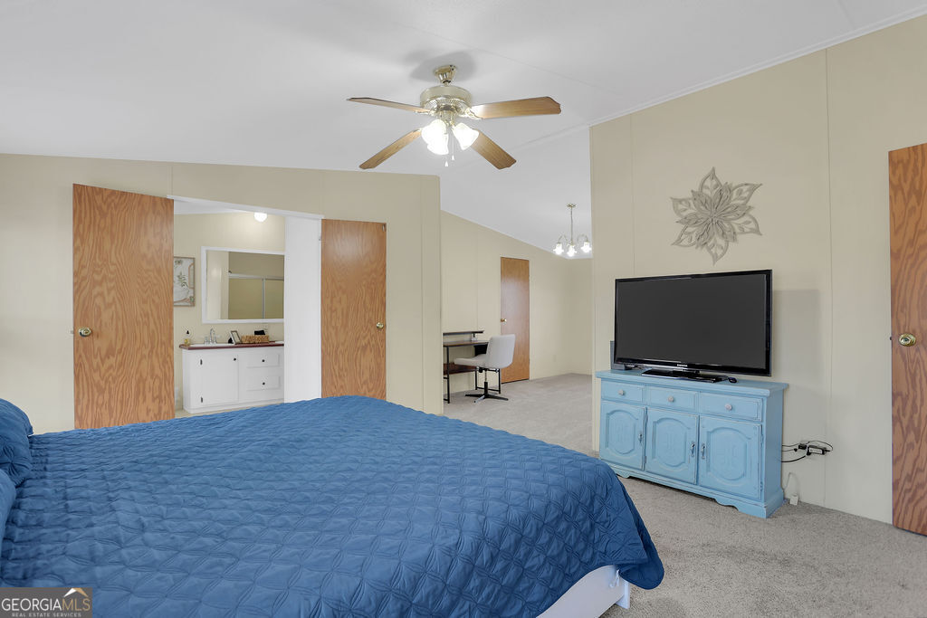 1775 Stoopto Road Sylvania, GA 30467 - Photo 23 of 66 a bedroom with a bed and a flat screen tv