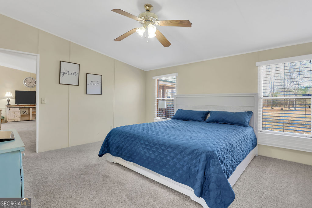 1775 Stoopto Road Sylvania, GA 30467 - Photo 24 of 66 a bedroom with a bed chandelier and a window