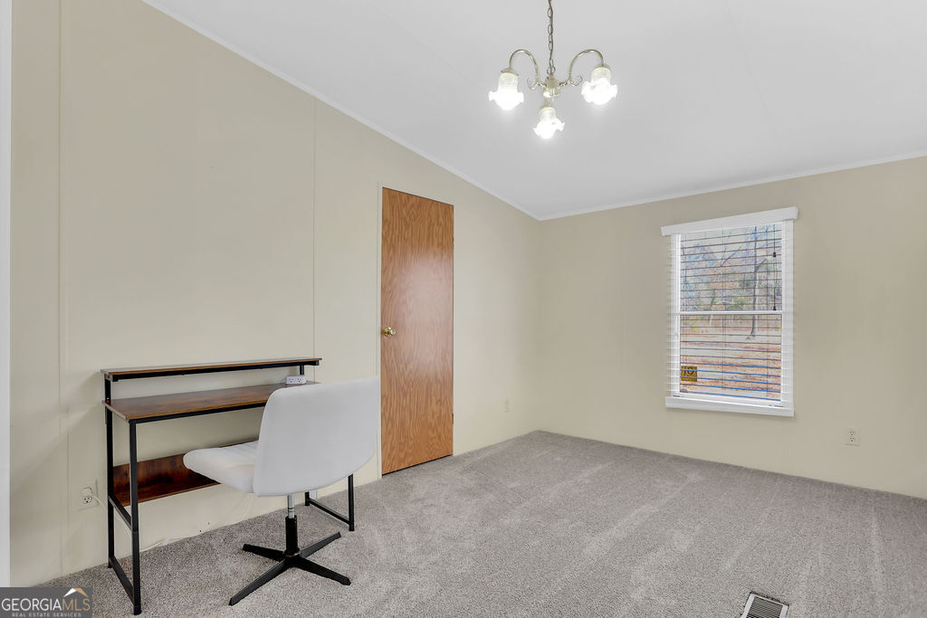 1775 Stoopto Road Sylvania, GA 30467 - Photo 26 of 66 a view of a livingroom with a piano and wooden floor