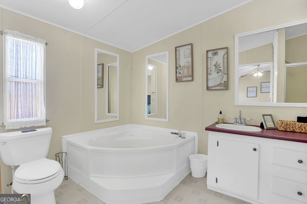 1775 Stoopto Road Sylvania, GA 30467 - Photo 27 of 66 a white bath tub sitting next to a white toilet