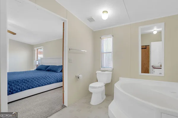 a bedroom with a bed and a night stand