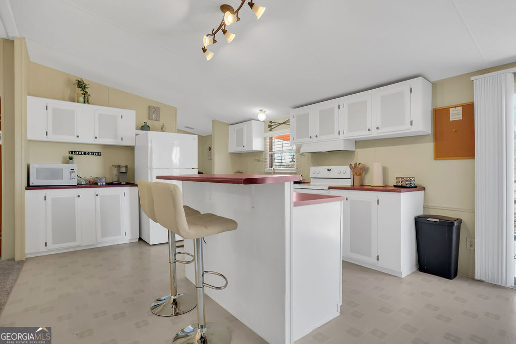 1775 Stoopto Road Sylvania, GA 30467 - Photo 3 of 66 a kitchen with kitchen island a counter top space a sink stainless steel appliances and cabinets