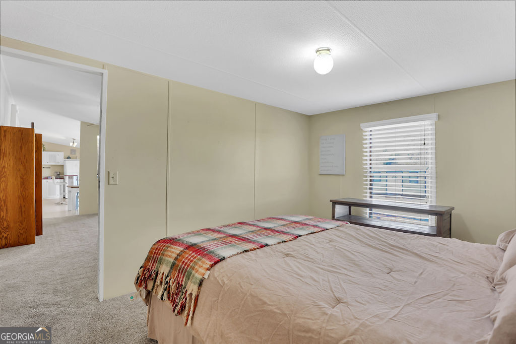 1775 Stoopto Road Sylvania, GA 30467 - Photo 34 of 66 a bedroom with a bed and a night stand