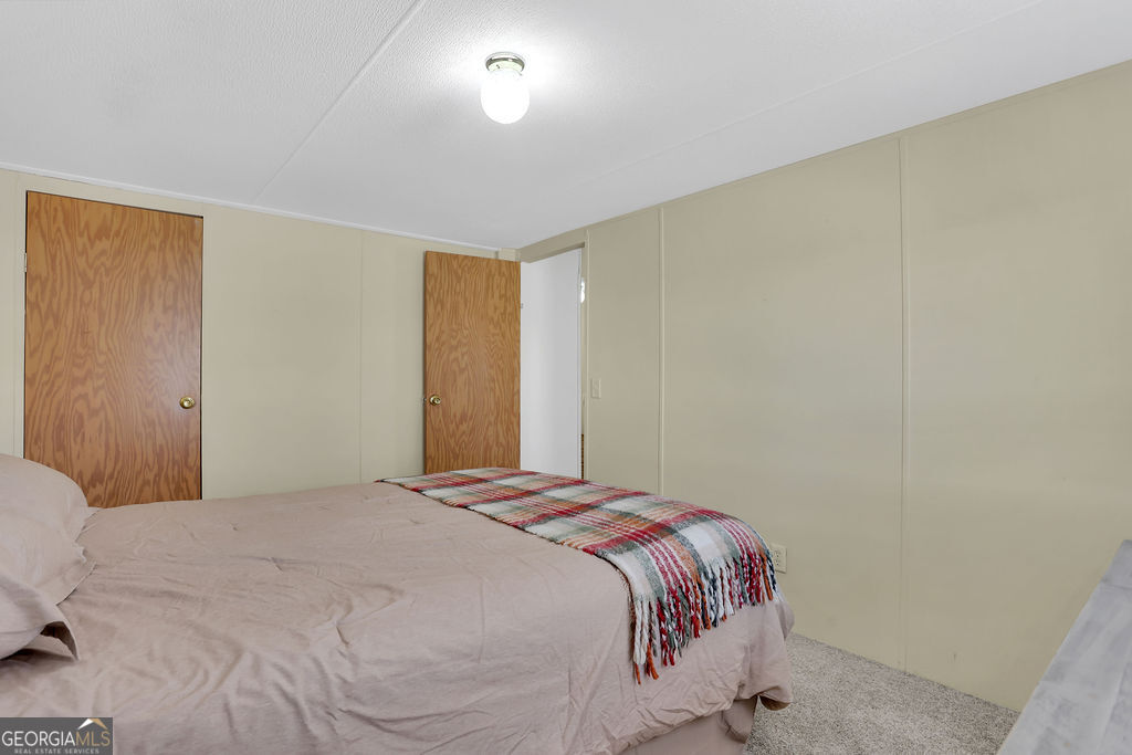 1775 Stoopto Road Sylvania, GA 30467 - Photo 35 of 66 a bedroom with a bed and a painting on the wall