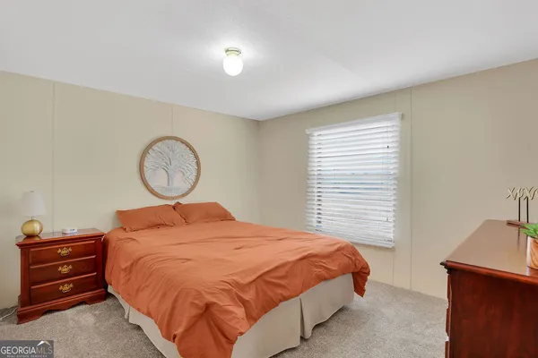 a bedroom with a bed and couch