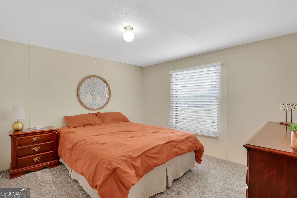 1775 Stoopto Road Sylvania, GA 30467 - Photo 36 of 66 a bed sitting in a room next to a window