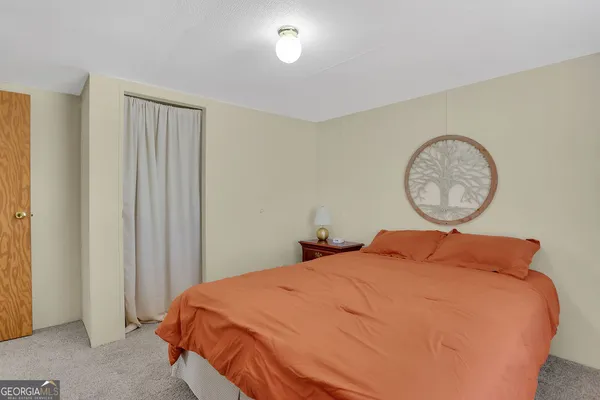a bedroom with a bed and dresser