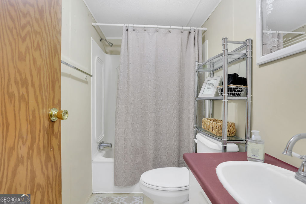 1775 Stoopto Road Sylvania, GA 30467 - Photo 39 of 66 a bathroom with a sink toilet and shower