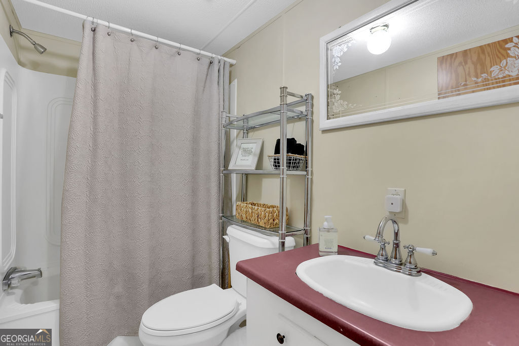 1775 Stoopto Road Sylvania, GA 30467 - Photo 40 of 66 a bathroom with a sink toilet and shower