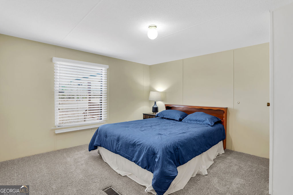 1775 Stoopto Road Sylvania, GA 30467 - Photo 41 of 66 a bedroom with a bed and a window
