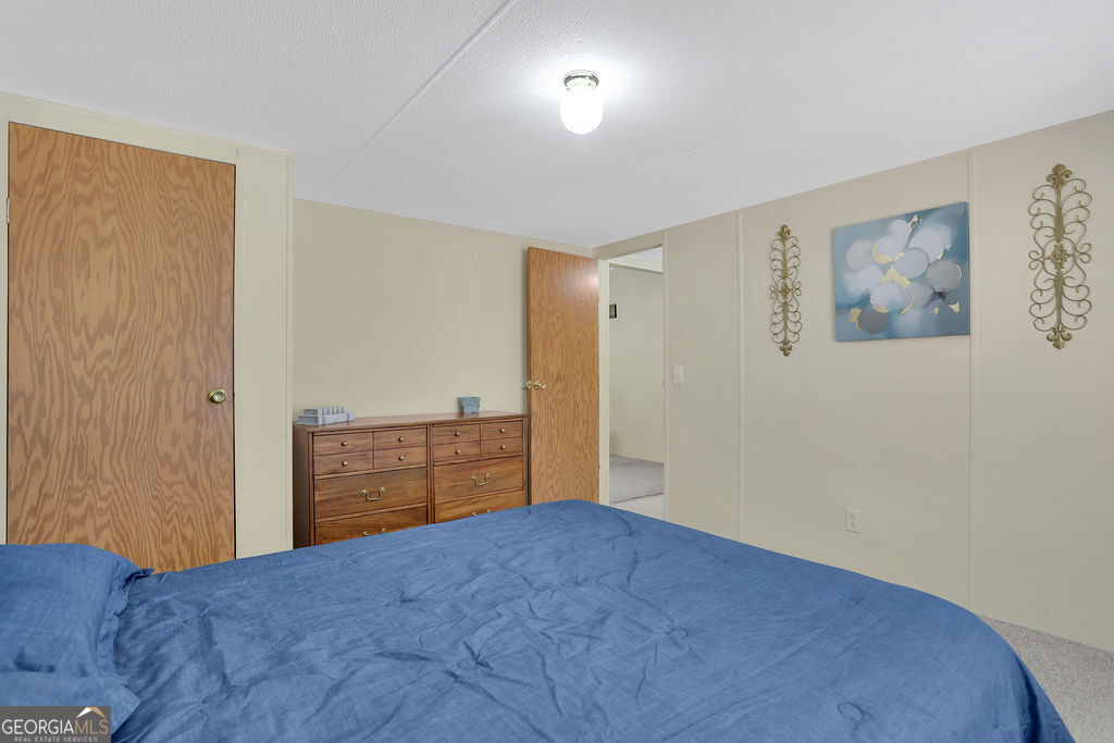 1775 Stoopto Road Sylvania, GA 30467 - Photo 42 of 66 a bedroom with a bed and couch