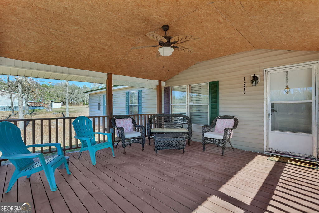 1775 Stoopto Road Sylvania, GA 30467 - Photo 44 of 66 a balcony with wooden floor outdoor seating and furniture