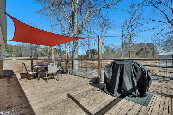 a view of a yard with wooden fence