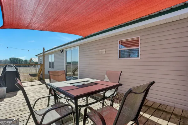 a view of a house with a yard patio and fire pit