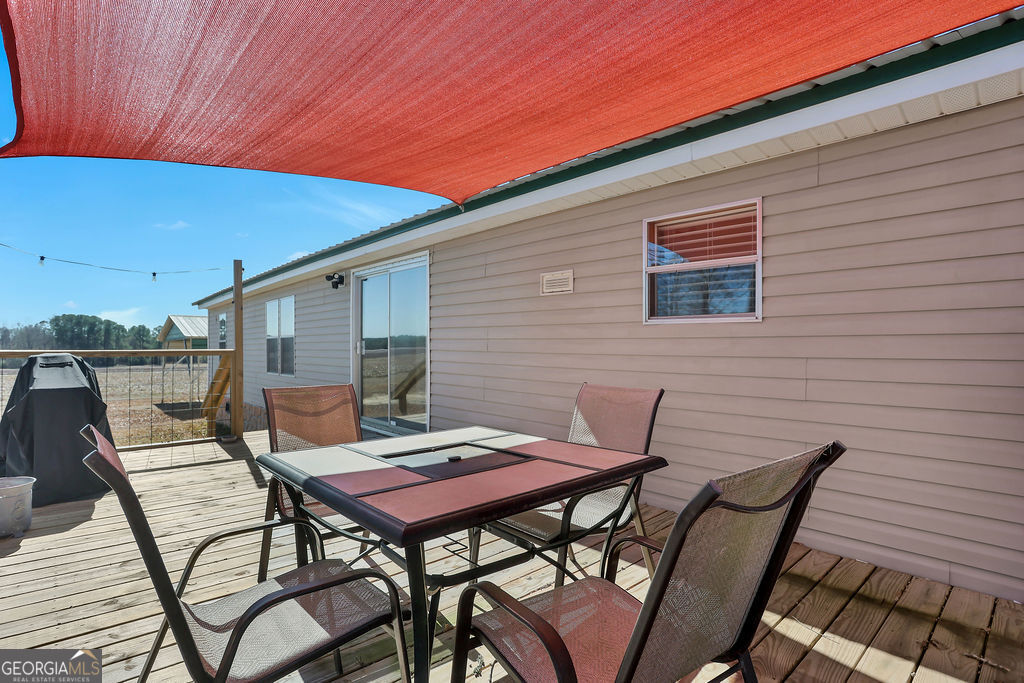 1775 Stoopto Road Sylvania, GA 30467 - Photo 47 of 66 a backyard of a house with table and chairs