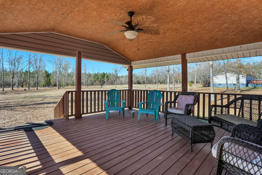 1775 Stoopto Road Sylvania, GA 30467 - Photo 5 of 66 a balcony with wooden floor and outdoor space