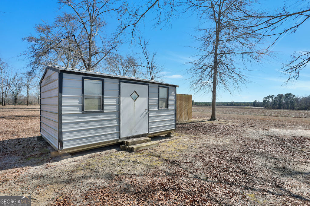 1775 Stoopto Road Sylvania, GA 30467 - Photo 52 of 66 a view of a house with a yard