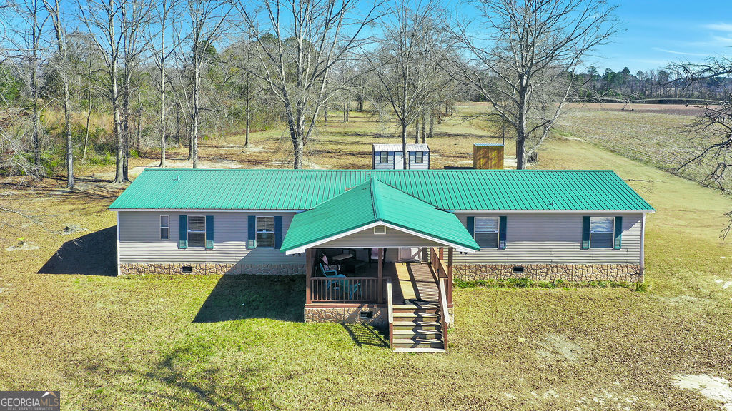 1775 Stoopto Road Sylvania, GA 30467 - Photo 56 of 66 a view of a house with a yard patio and fire pit