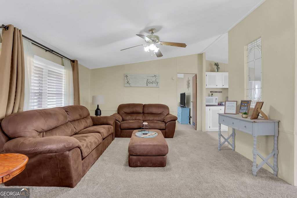 1775 Stoopto Road Sylvania, GA 30467 - Photo 7 of 66 a living room with furniture and a large window