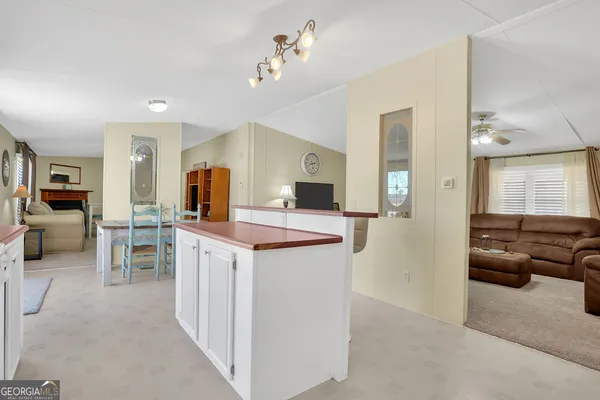 a view of living room kitchen with furniture and fireplace