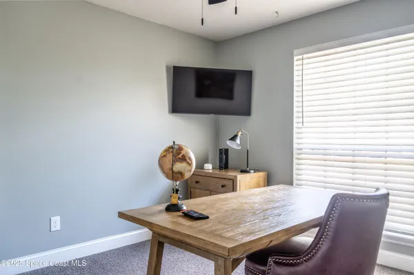a view of a workspace with furniture