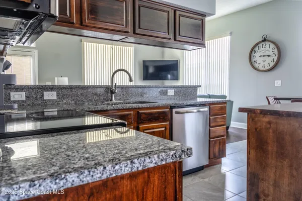 a kitchen with stainless steel appliances granite countertop a sink stove and cabinets