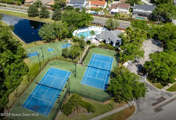 an aerial view of a house with a yard and lake view