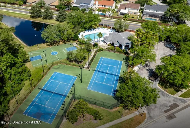 an aerial view of a house with a yard and lake view