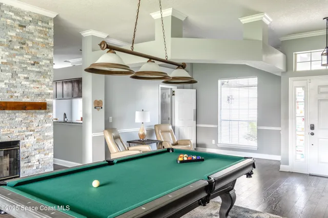 a room with pool table and windows