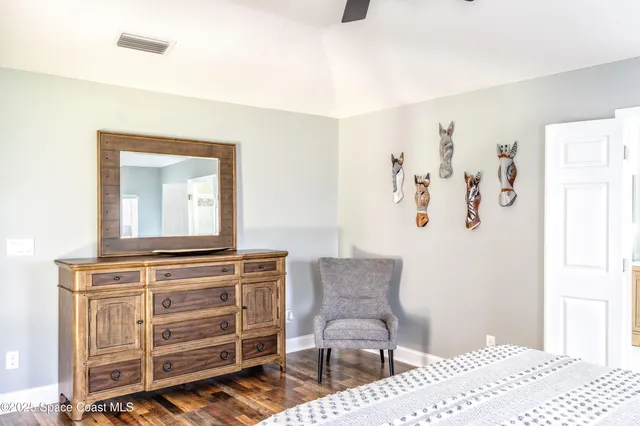 a view of a bedroom with furniture and cabinet